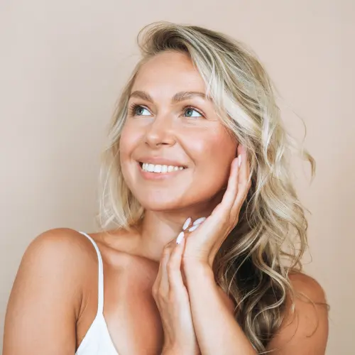 Beauty portrait of blonde hair smiling young woman isolated on b