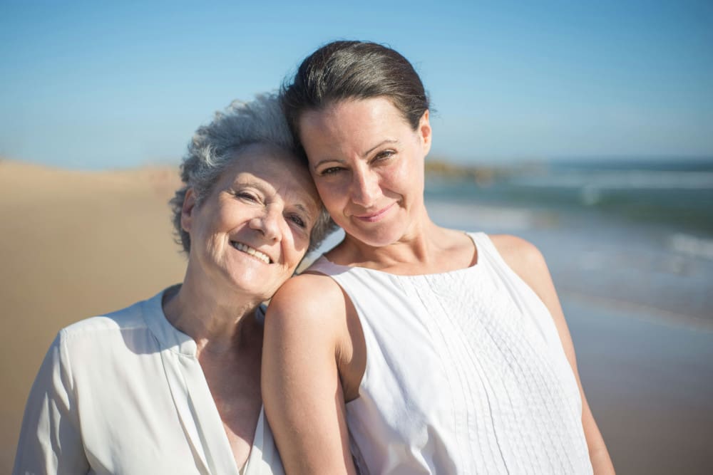 older women in white on beach