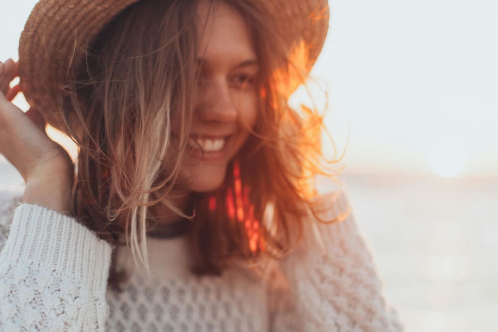 woman in hat at the beach