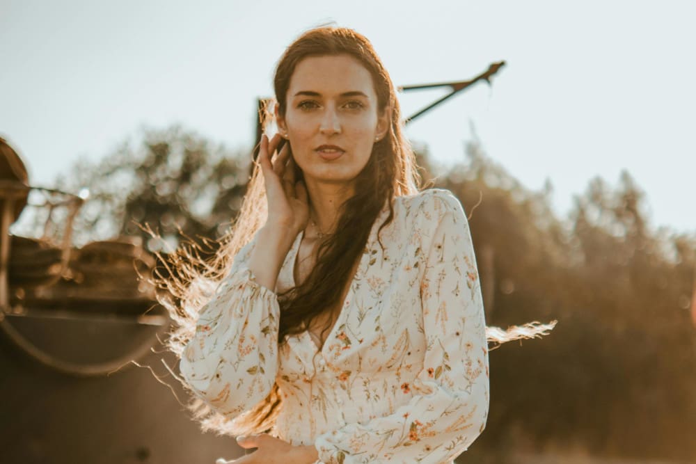 woman with floral shirt and long hair